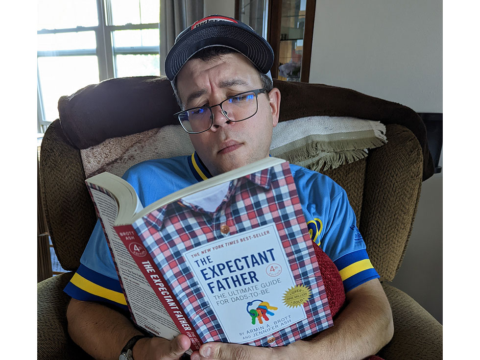 Brent reading the book called Expectant Father